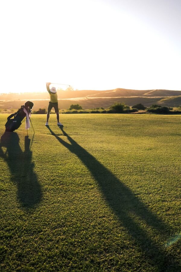 Photo by Matt Aylward 2 person walking on green grass field during daytime