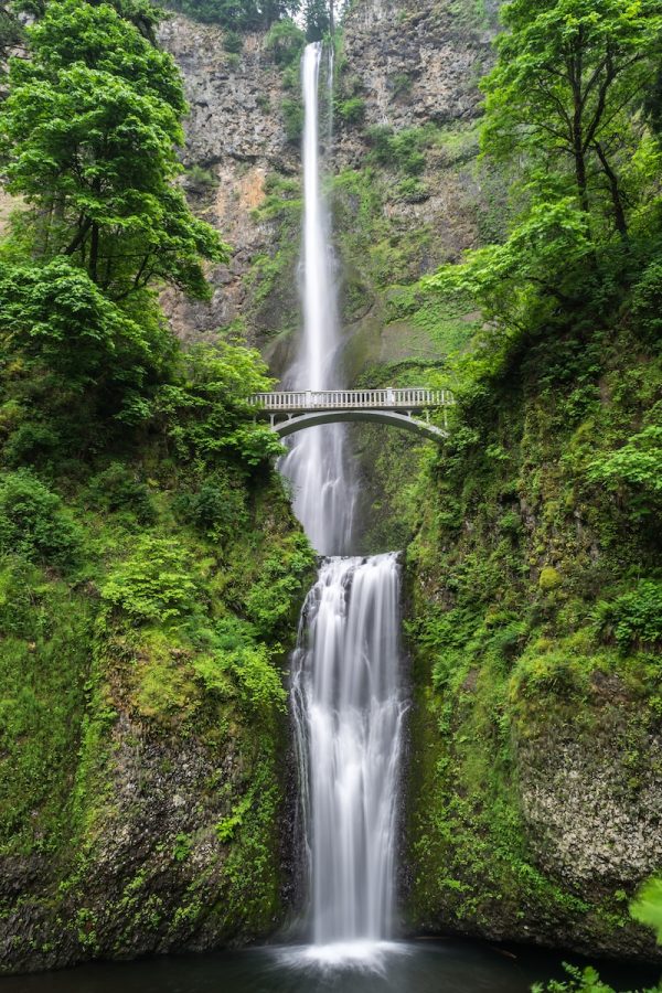 Photo by Blake Verdoorn gray concrete bridge and waterfalls during daytime