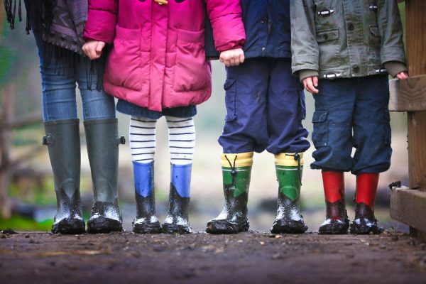 Photo by Ben Wicks four children standing on dirt during daytime