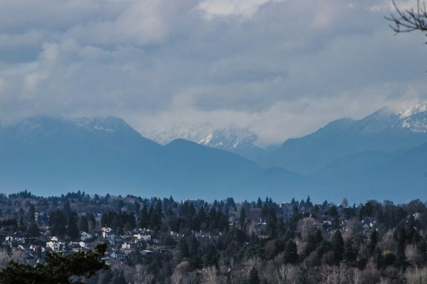 Photo by Peter Robbins a view of a city with mountains in the background