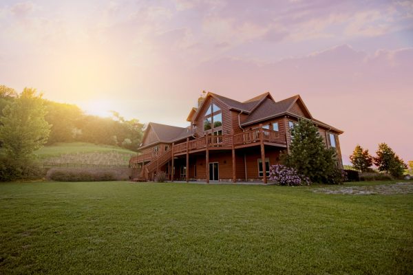 Photo by Bailey Anselme brown wooden house with green grass field