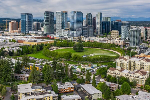 Photo by Zac Gudakov high rise buildings near green trees and road during daytime